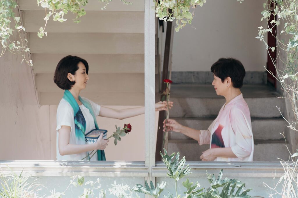 《一家之主》鮑起靜跟柯佳嬿飾演母女_兩人傳遞玫瑰花給彼此_台北双喜電影提供