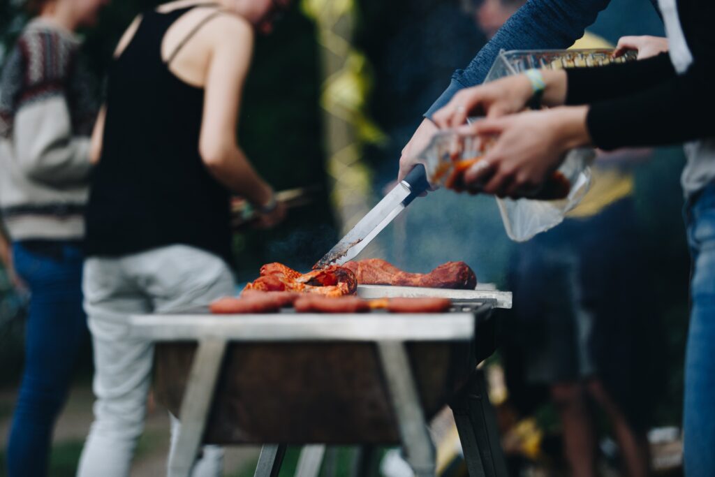 person slicing meat on white ceramic plate